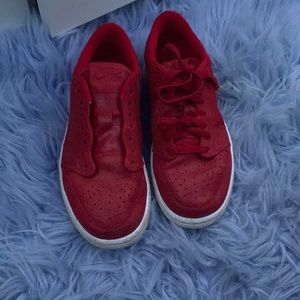 Red nike air forces. One lace is missing.